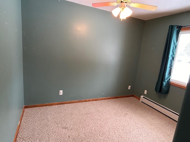 empty room featuring carpet flooring, ceiling fan, and baseboard heating