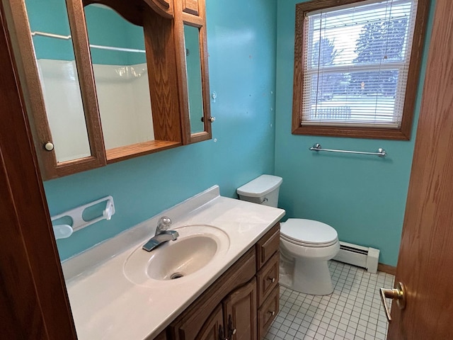 bathroom with tile patterned flooring, vanity, toilet, and baseboard heating