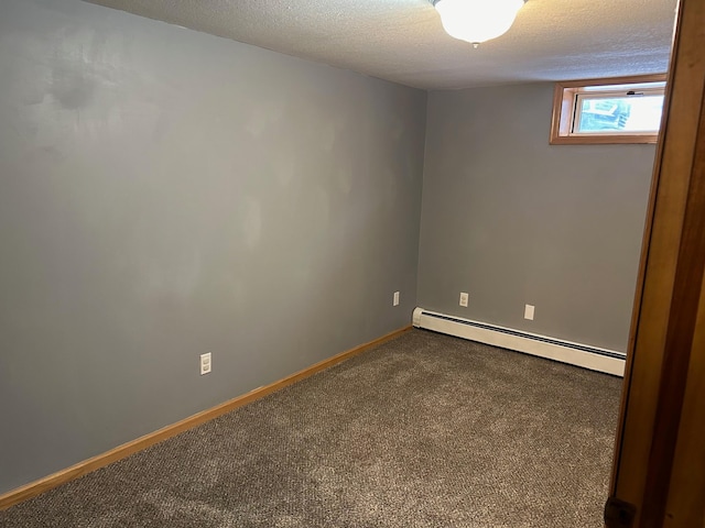 carpeted empty room featuring a textured ceiling and a baseboard radiator