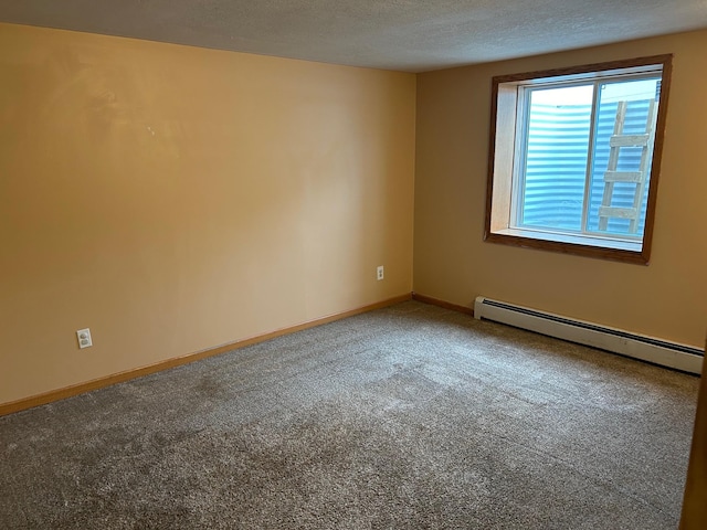 carpeted spare room with baseboard heating and a textured ceiling