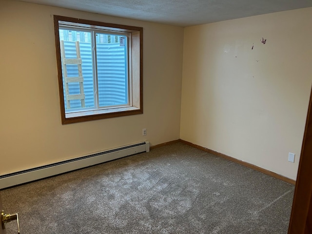 carpeted spare room featuring a baseboard heating unit