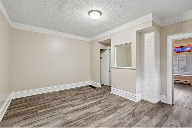 unfurnished bedroom featuring hardwood / wood-style flooring, ornamental molding, a textured ceiling, and a baseboard radiator