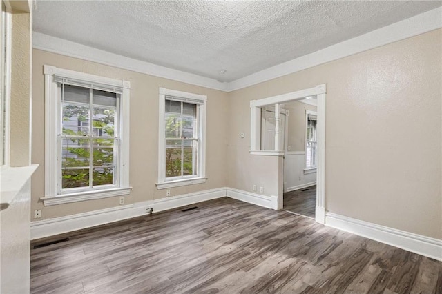 empty room featuring dark hardwood / wood-style flooring and a textured ceiling