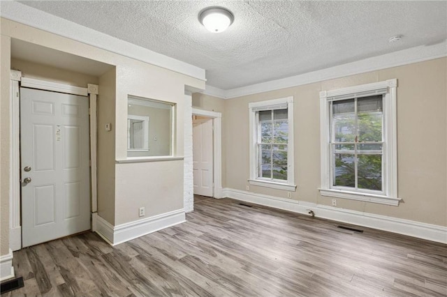 interior space featuring hardwood / wood-style flooring and a textured ceiling