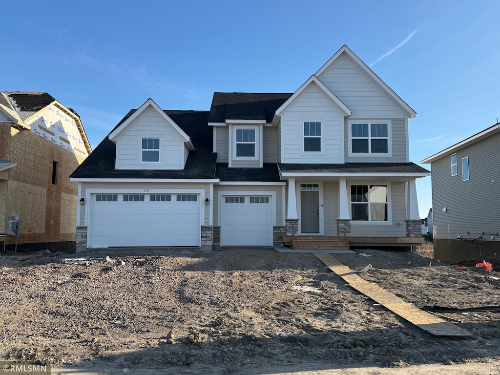 view of front of house with a porch and a garage