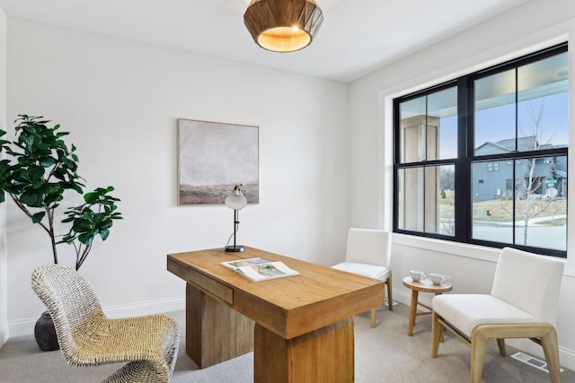 office with light colored carpet and a wealth of natural light