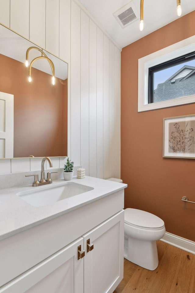 bathroom featuring hardwood / wood-style floors, vanity, and toilet