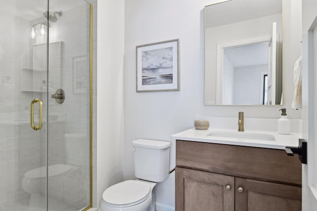 bathroom featuring vanity, toilet, and an enclosed shower