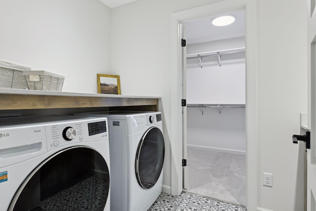 washroom featuring washing machine and dryer and light carpet