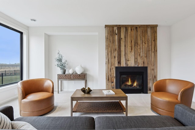 sitting room with carpet and a large fireplace