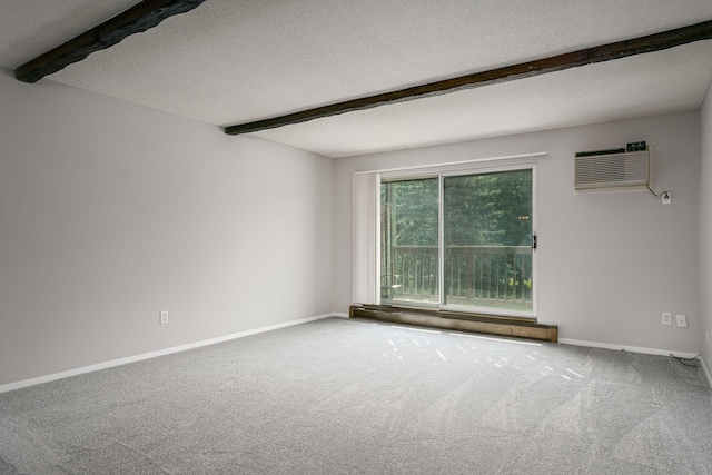 carpeted spare room featuring beam ceiling, a healthy amount of sunlight, a textured ceiling, and an AC wall unit