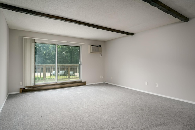 carpeted spare room featuring a wall mounted air conditioner, beam ceiling, baseboard heating, and a textured ceiling