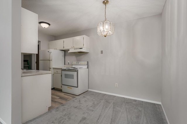 kitchen with a textured ceiling, white appliances, a notable chandelier, white cabinets, and hanging light fixtures