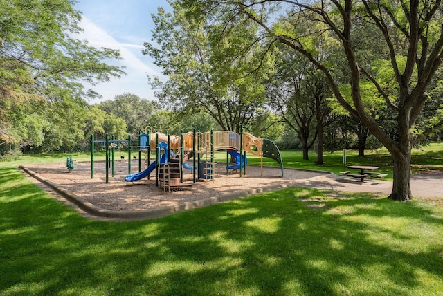 view of playground with a lawn