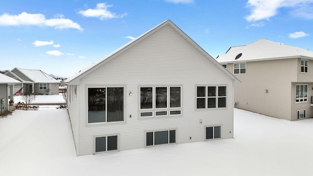 view of snow covered rear of property