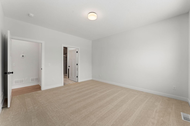 unfurnished room with light colored carpet