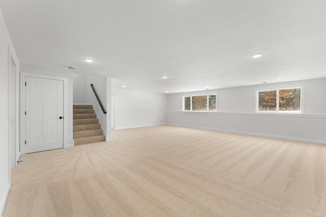 interior space with light colored carpet and a textured ceiling