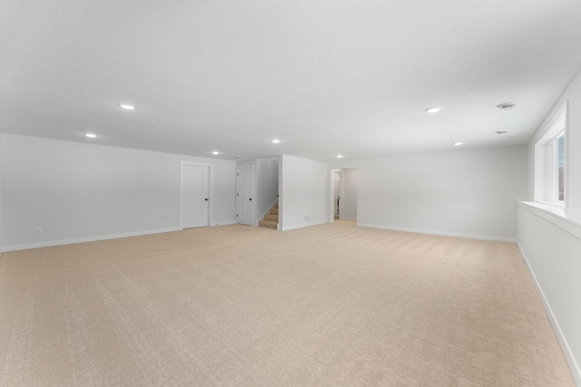 basement featuring light carpet