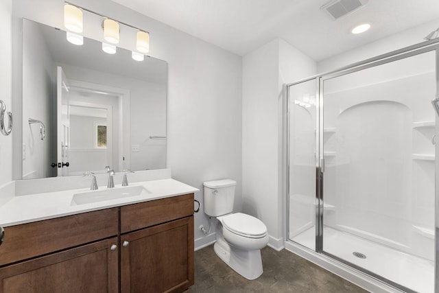 bathroom featuring a shower with door, vanity, and toilet