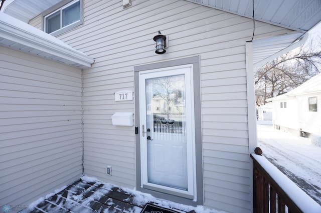 view of snow covered property entrance