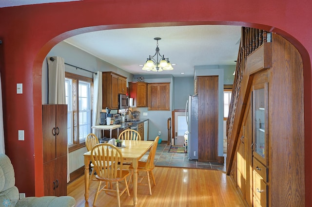 dining room featuring wood-type flooring and a chandelier