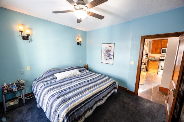 bedroom with carpet, a textured ceiling, and ceiling fan