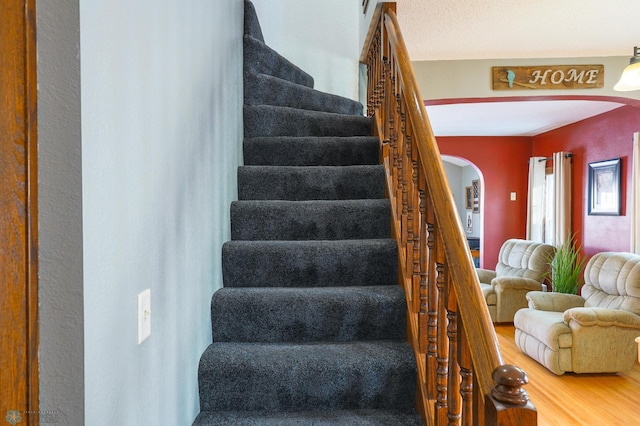 stairs featuring hardwood / wood-style floors