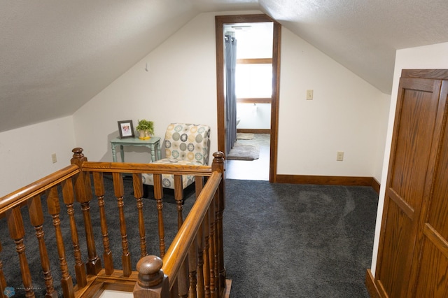 additional living space with vaulted ceiling and carpet