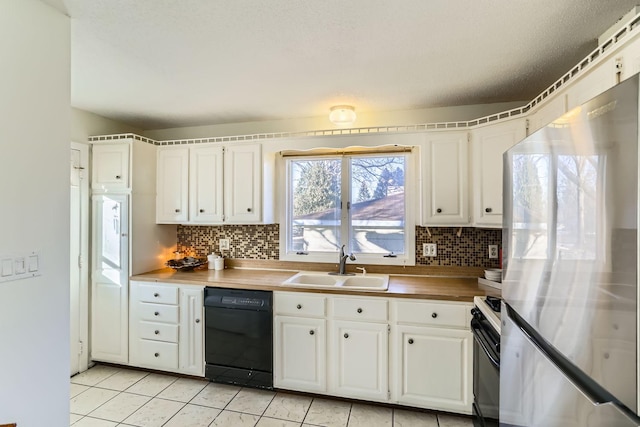 kitchen with stainless steel fridge, dishwasher, and white cabinets