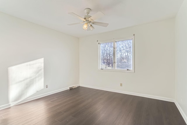 unfurnished room with ceiling fan and dark wood-type flooring