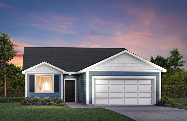 single story home featuring a garage and a yard