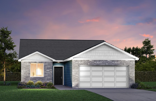 view of front facade featuring a garage and a lawn