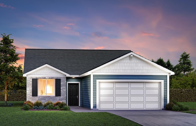 view of front facade with a yard and a garage