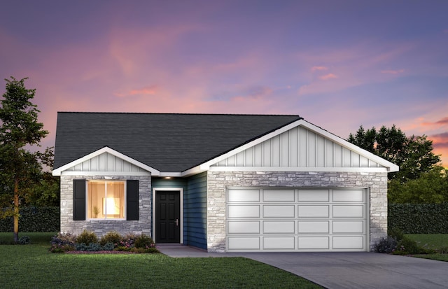 view of front of home with a lawn and a garage