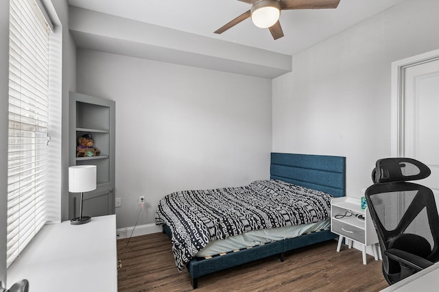 bedroom featuring multiple windows, dark hardwood / wood-style flooring, and ceiling fan