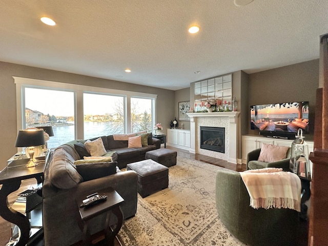 living room with a textured ceiling and a water view