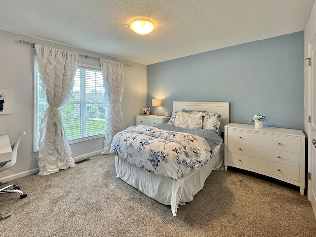 carpeted bedroom with a textured ceiling