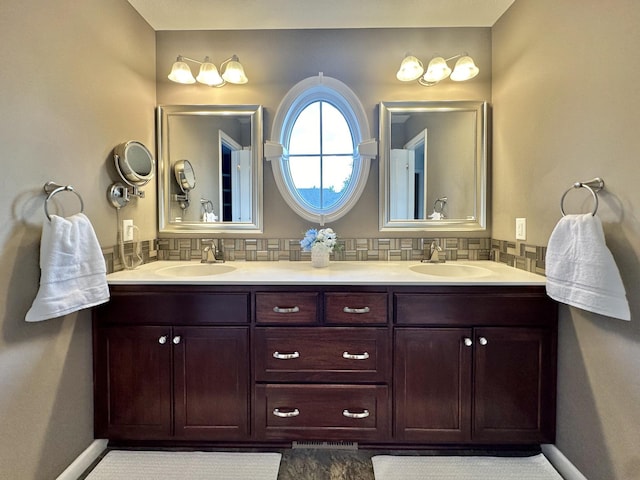 bathroom with tasteful backsplash and vanity