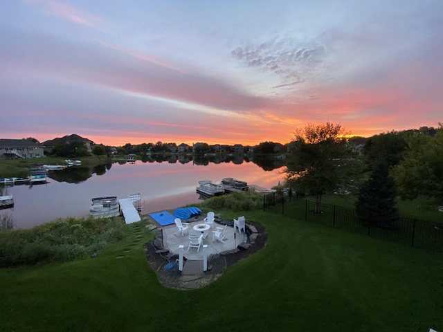 aerial view at dusk with a water view