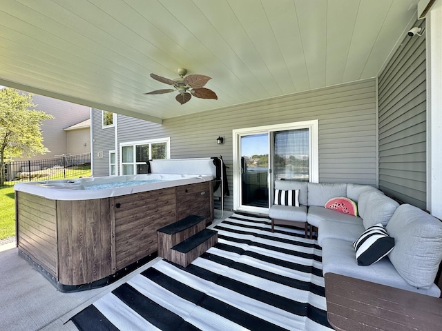 view of patio featuring ceiling fan, outdoor lounge area, and a hot tub