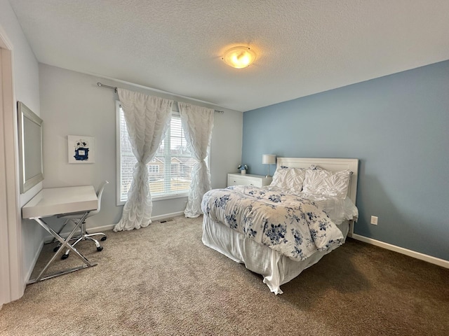 bedroom featuring carpet floors, baseboards, and a textured ceiling