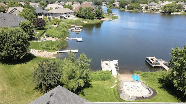 drone / aerial view featuring a residential view and a water view