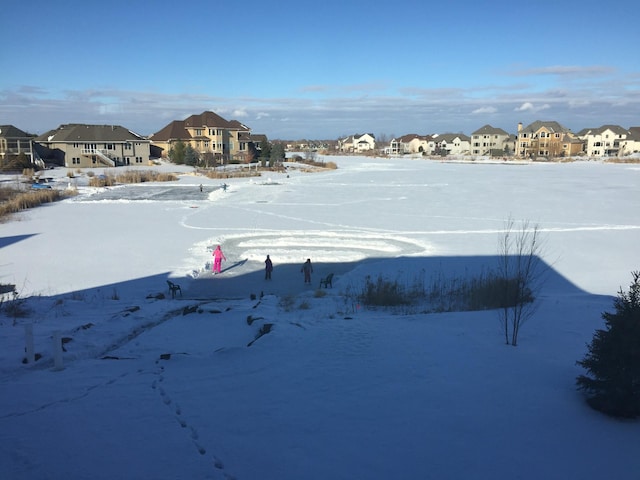 yard covered in snow featuring a residential view