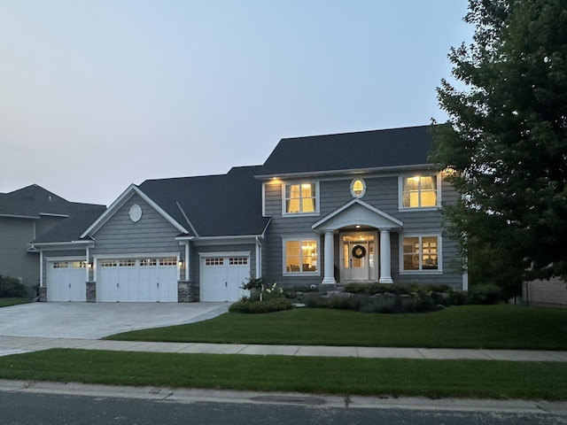 view of front of house with concrete driveway and a front lawn