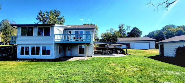 back of property featuring a patio area, a yard, an outbuilding, and a wooden deck