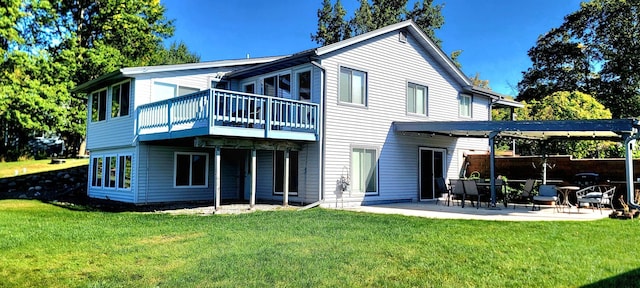 back of house with a yard and a patio