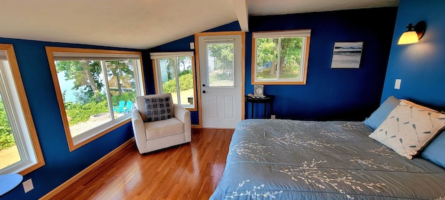 unfurnished bedroom featuring wood-type flooring and vaulted ceiling