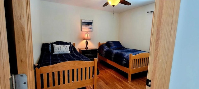 bedroom with ceiling fan and hardwood / wood-style floors