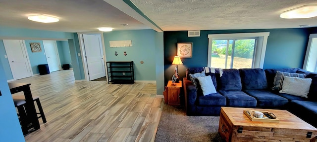 living room with hardwood / wood-style floors and a textured ceiling