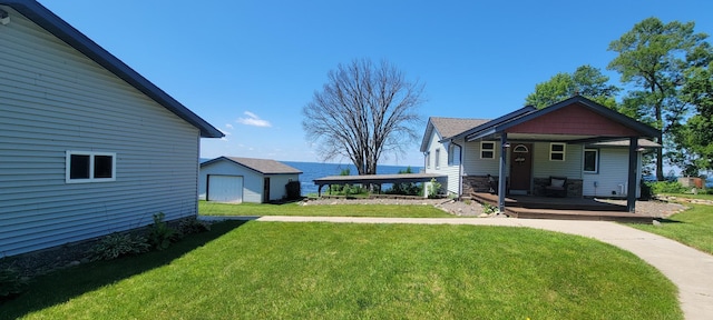 view of yard featuring covered porch and an outdoor structure